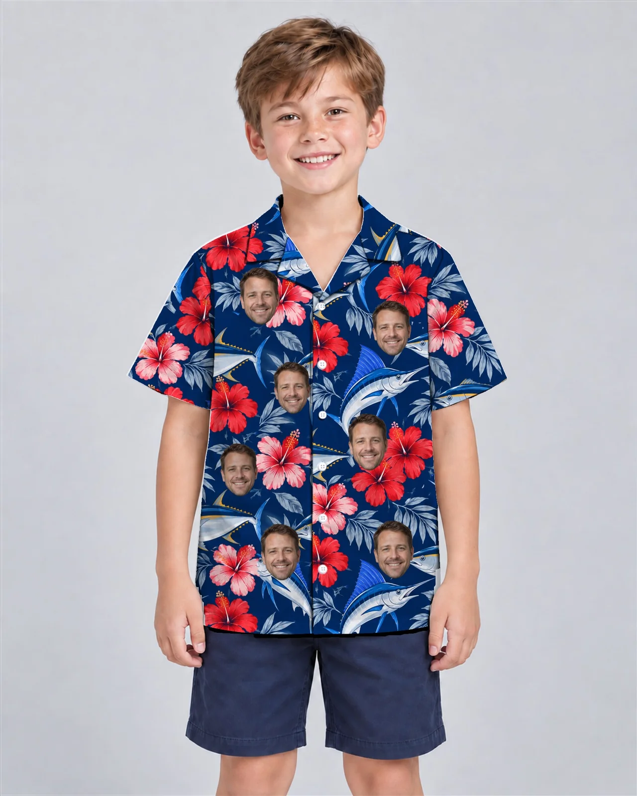 Kid wearing the Fish & Hibiscus Hawaiian Shirt with custom faces Kid wearing the Fish & Hibiscus Hawaiian Shirt with custom faces