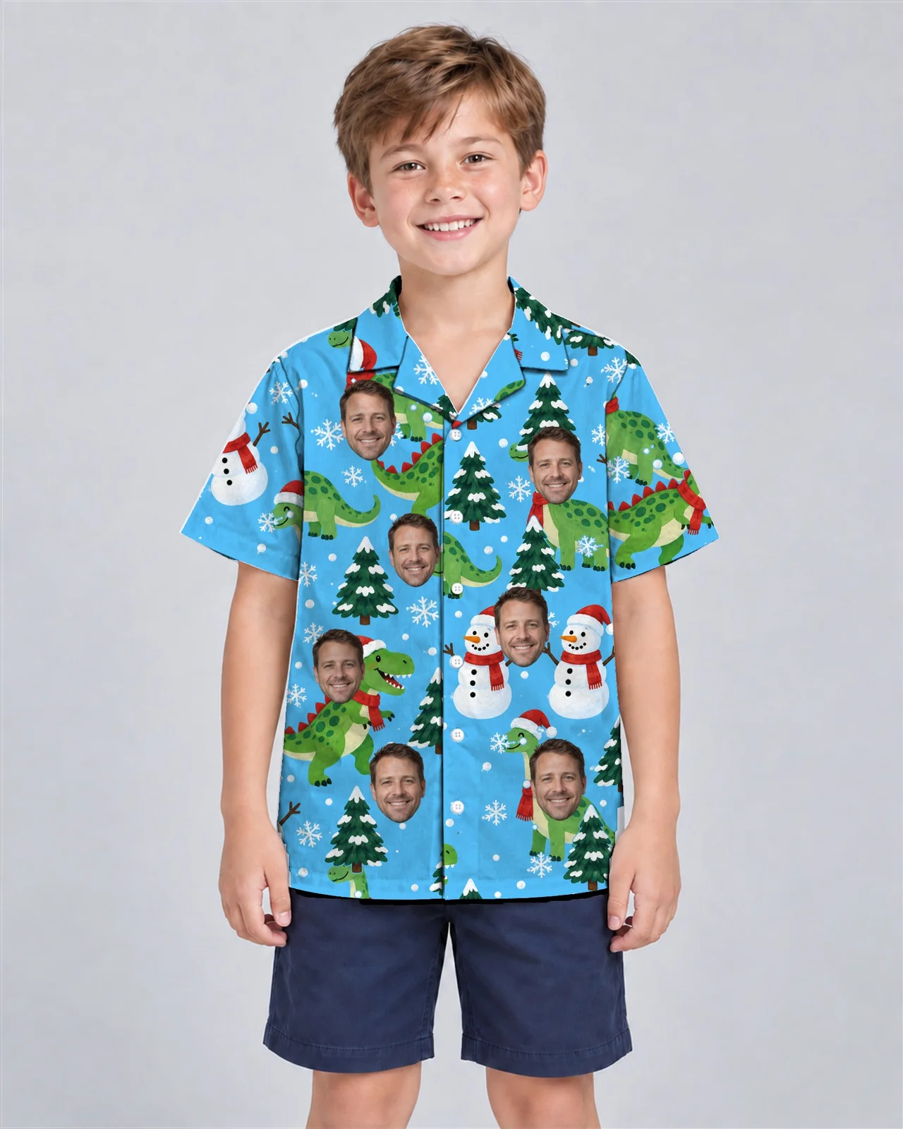 Kid wearing the Snowy Dino Christmas Hawaiian Shirt with custom faces Kid wearing the Snowy Dino Christmas Hawaiian Shirt with custom faces