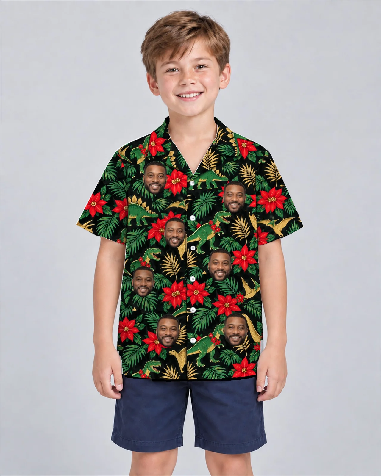 Kid wearing the Tropical Dino Christmas Hawaiian Shirt with custom faces Kid wearing the Tropical Dino Christmas Hawaiian Shirt with custom faces